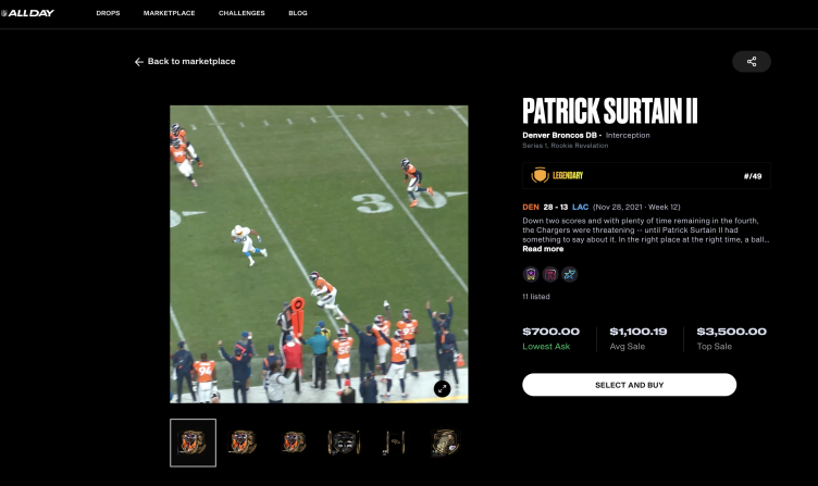 NFL player Patrick Surtain making an interception during a game, wearing orange jersey.