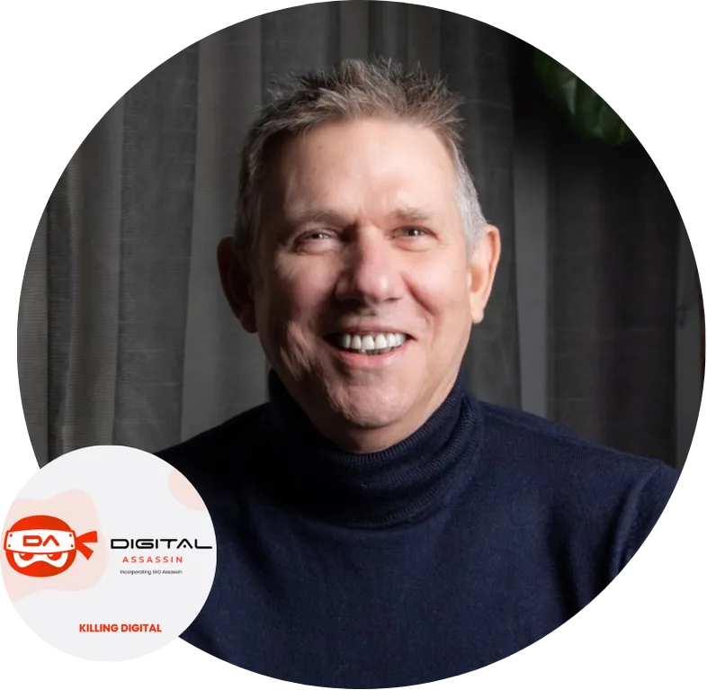 Smiling man in dark sweater with digital assassin logo in background